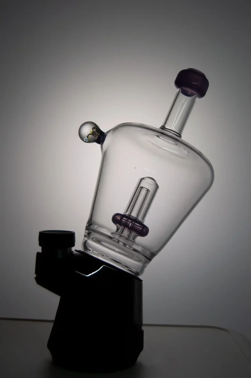 Puffco Peak glass attachment with Wiidz Titan installed, positioned facing east, beautifully backlit, scaled for a sleek appearance.