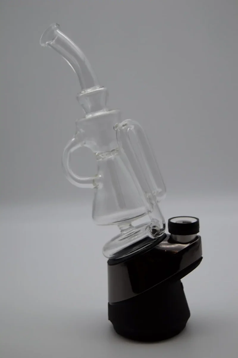 Puffco Peak Pro glass attachment featuring a Wiidz recycler, installed and oriented towards the west, showcasing its sleek design and functionality in a vibrant setting.
